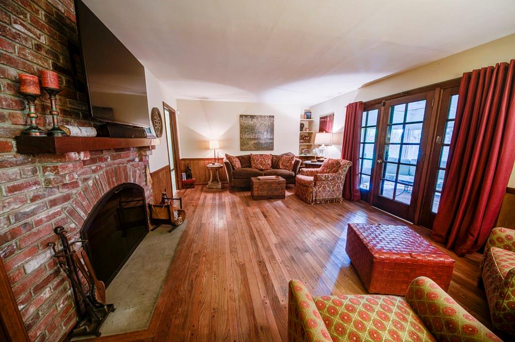 404 Gass Road Wexford, PA 15090 - Photo 6 of 20 The family room is kept cozy with the oversized brick, log-burning fireplace and hardwood flooring. French Doors lead to Screened Porch.