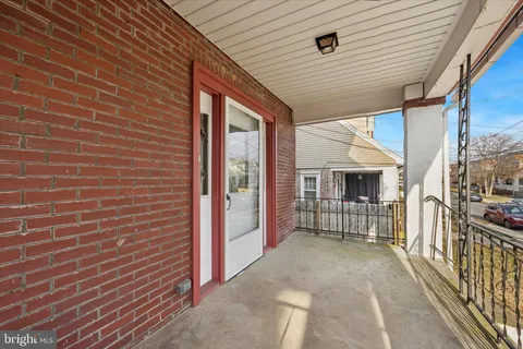 a view of a porch with wooden floor and fence