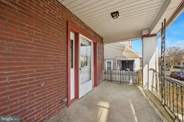 a view of a porch with wooden floor and fence