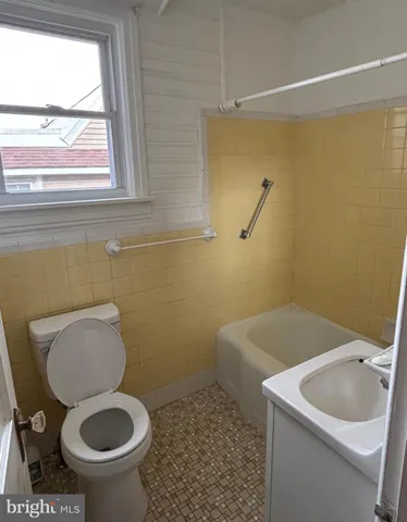 a bathroom with a sink toilet and mirror