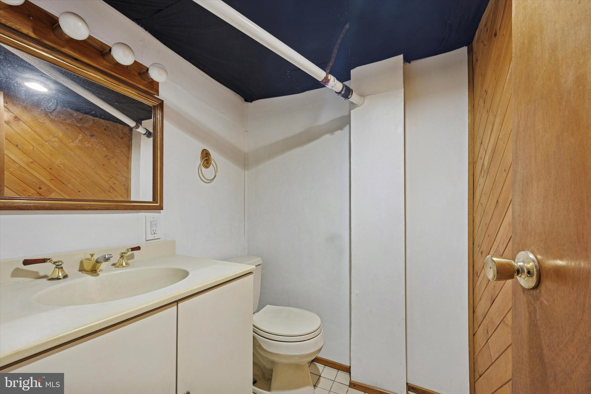 1114 Roosevelt Drive Havertown, PA 19083 - Photo 13 of 14 a bathroom with a sink and mirror with toilet