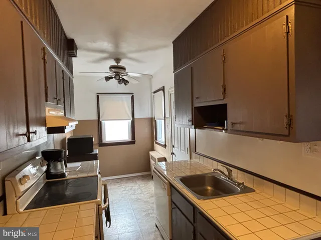 a kitchen with a sink stove and microwave