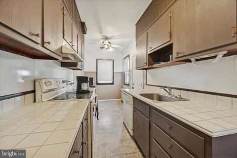 a kitchen with stainless steel appliances granite countertop a sink and a stove