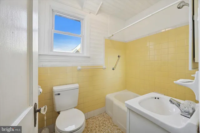 a white toilet sitting next to a bathroom sink