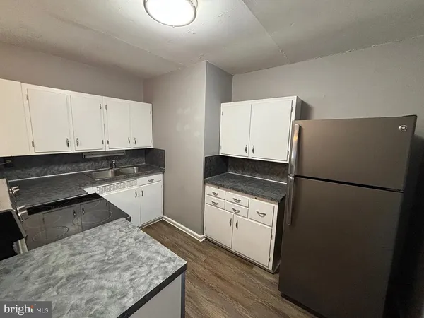 a kitchen with a stove and white cabinets