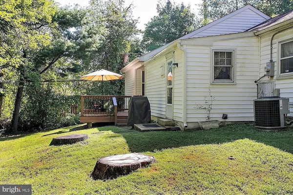 a deck with hardwood and outdoor seating