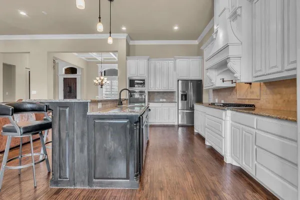 a kitchen with cabinets a sink and stainless steel appliances