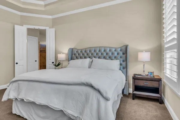 a bedroom with a bed and window