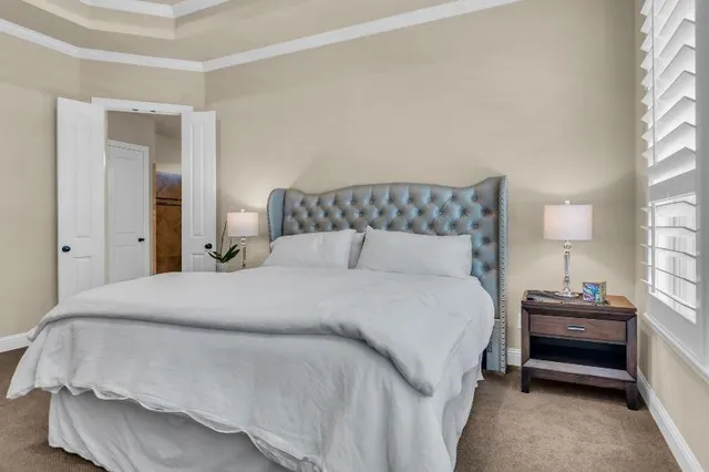 a bedroom with a bed and window