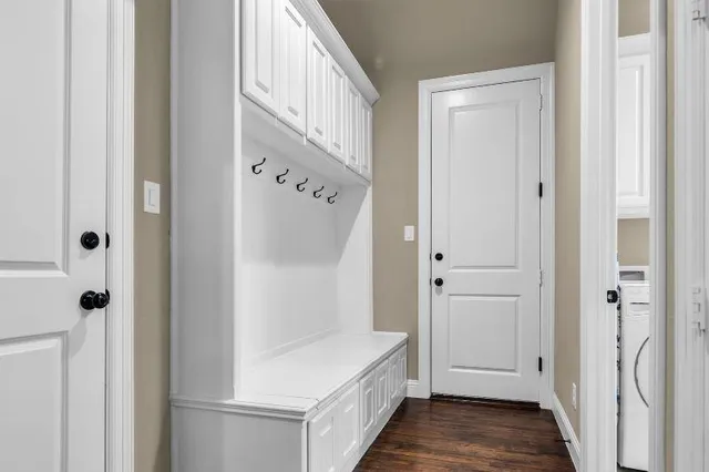 a bathroom with a granite countertop sink a toilet and mirror