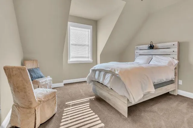 a bathroom with a granite countertop sink a toilet and a mirror
