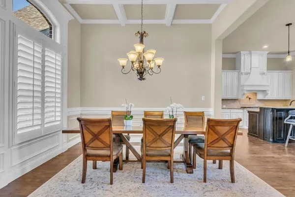 a view of a dining room with furniture and chandelier
