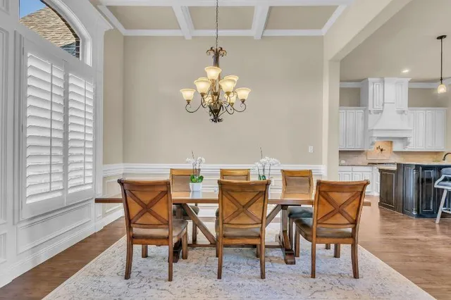 a view of a dining room with furniture and chandelier