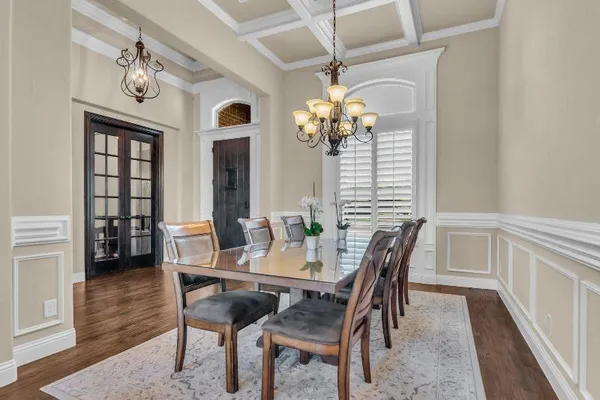 a view of a dining room with furniture and chandelier