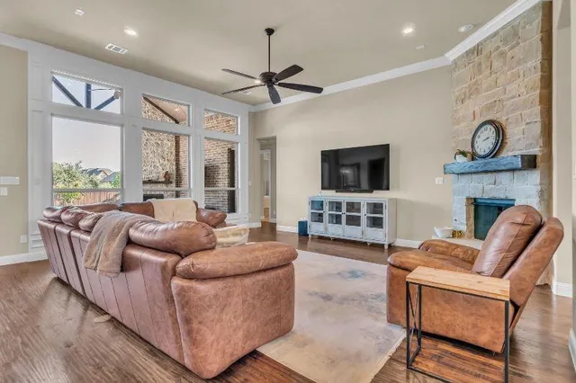 a living room with furniture a flat screen tv and a fireplace