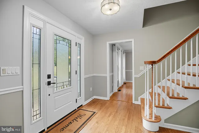 a view of an entryway with wooden floor