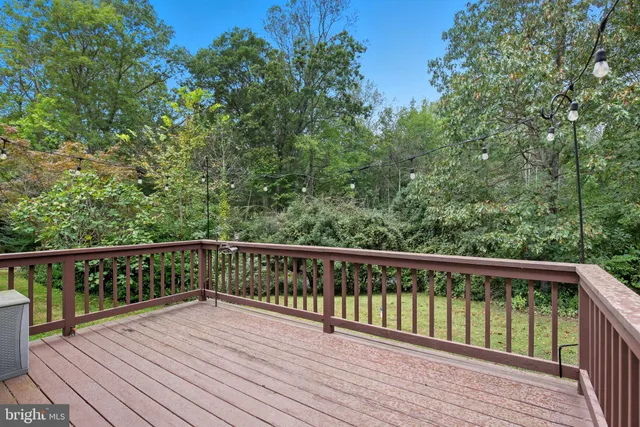a view of balcony with wooden floor and fence