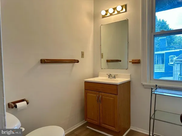 a bathroom with a sink a toilet and mirror