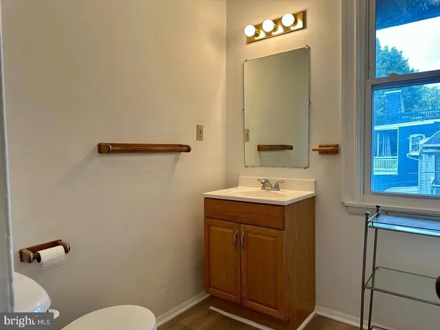 a bathroom with a sink a toilet and mirror
