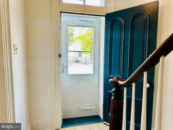 a view of an entryway with wooden floor and stairs