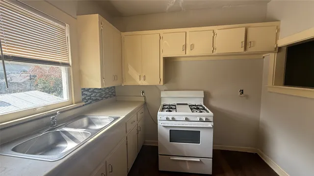 a kitchen with a sink and a stove top oven