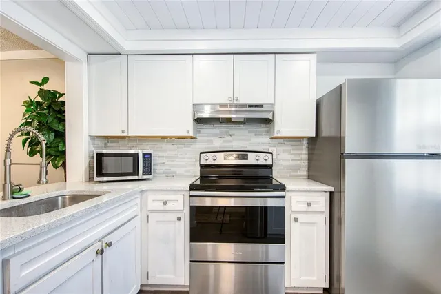 a kitchen with a refrigerator stove and microwave