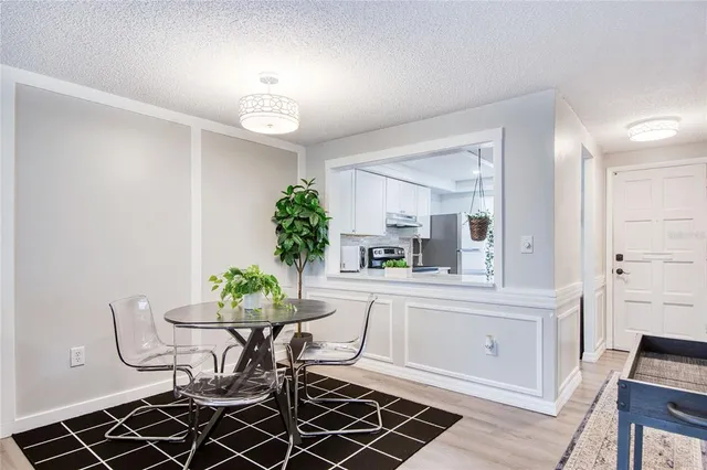 a view of a dining room with furniture and chandelier