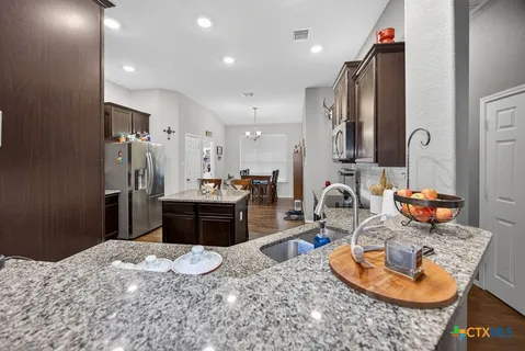 a bathroom with a sink a granite counter and a sink
