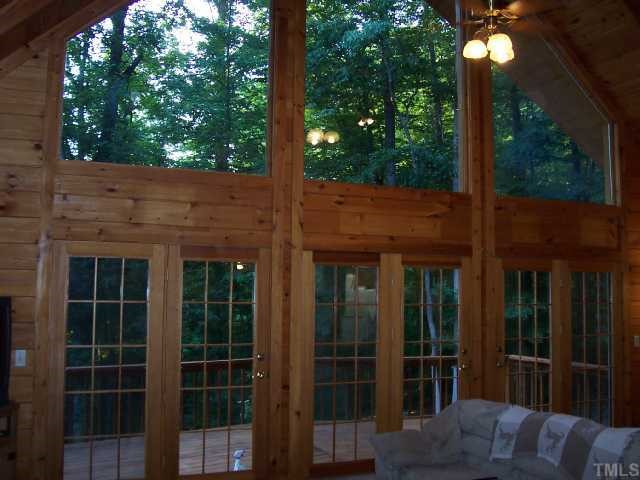 280 Indian Trail Road Timberlake, NC 27583 - Photo 2 of 11 a view of a brick house with a large windows and a large tree