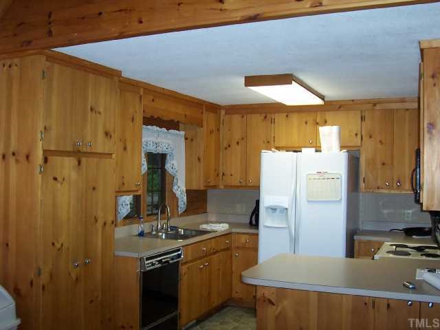 280 Indian Trail Road Timberlake, NC 27583 - Photo 3 of 11 a kitchen with stainless steel appliances a refrigerator a stove and a sink