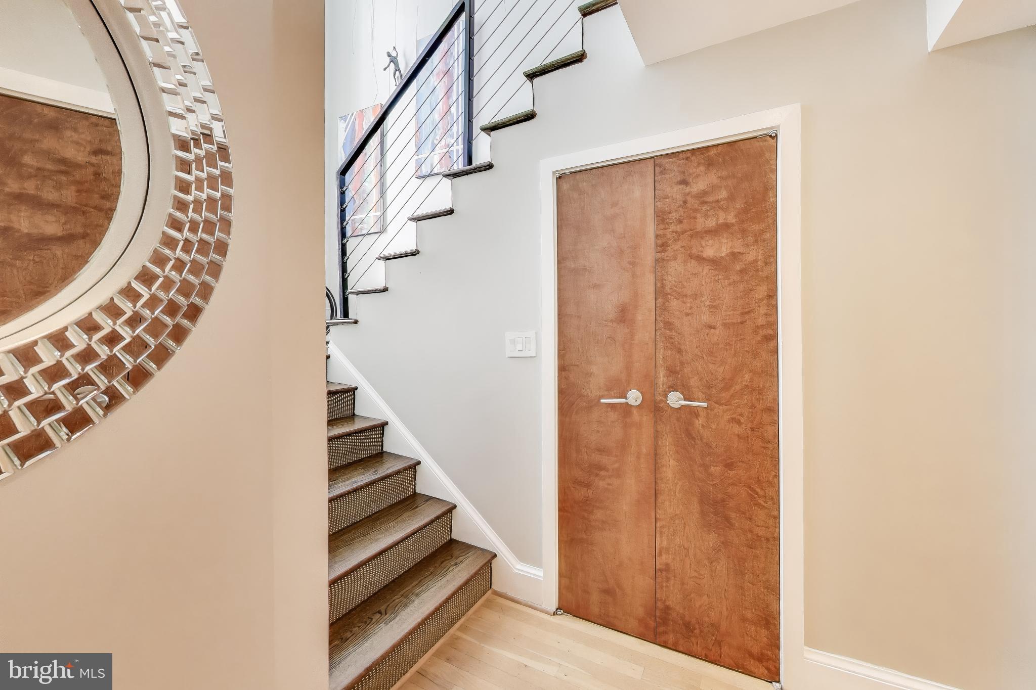 a view of entryway and hall with wooden floor