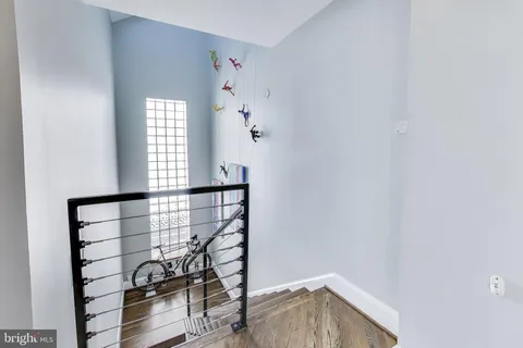 a view of entryway and hall with wooden floor