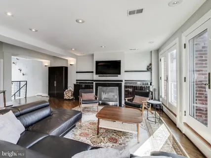a living room with fireplace furniture and a flat screen tv