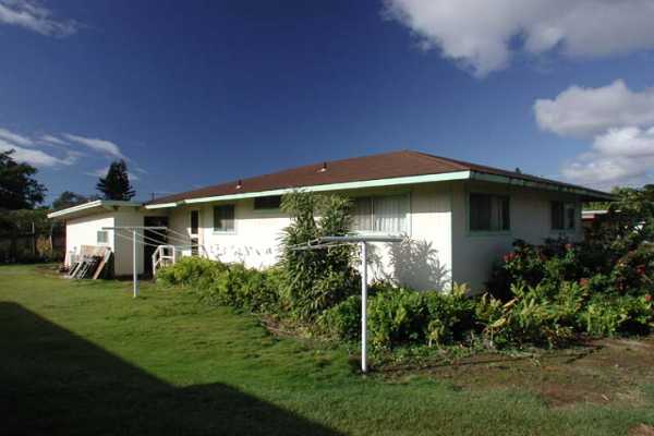 3369 Puni Road Koloa, HI 96756 - Photo 1 of 11 a front view of a house with a yard