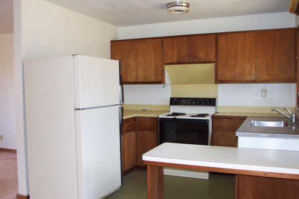 3369 Puni Road Koloa, HI 96756 - Photo 3 of 11 a kitchen with a refrigerator and a sink