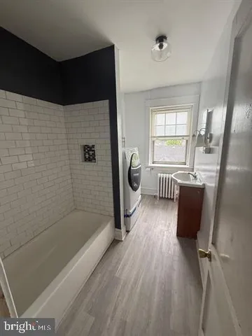 a bathroom with a tub toilet and sink