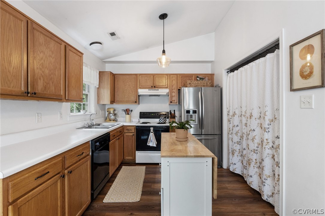 317 South Ridge Road Bumpass, VA 23024 - Photo 13 of 36 a kitchen with stainless steel appliances kitchen island granite countertop a refrigerator a sink dishwasher a stove with wooden cabinets and floor