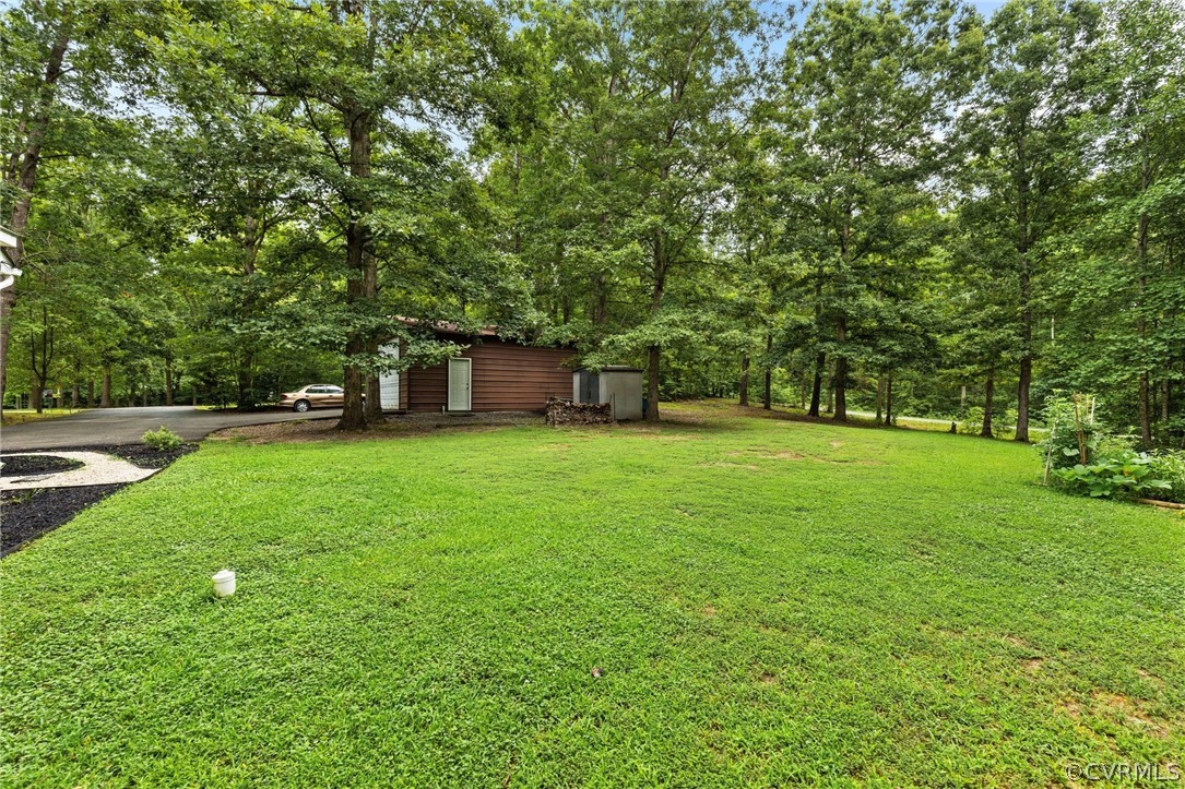 317 South Ridge Road Bumpass, VA 23024 - Photo 33 of 36 a backyard of a house with lots of green space