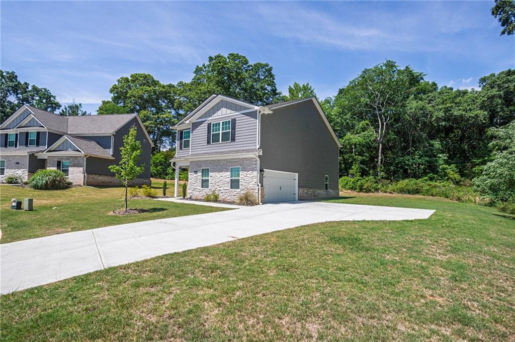 635 Meadows Farm Way Monroe, GA 30655 - Photo 2 of 36 a front view of a house with a yard and garage