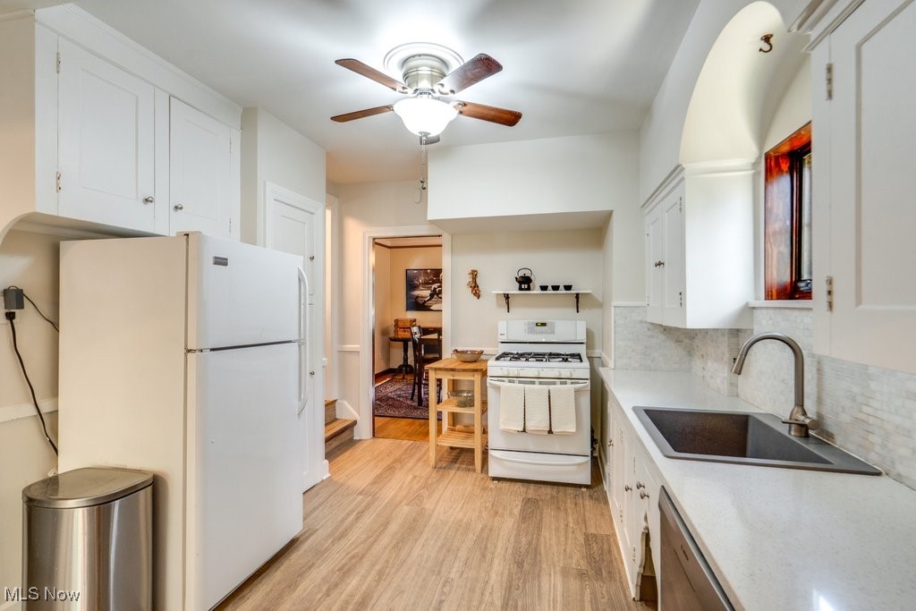 3849 Faversham Road Cleveland, OH 44118 - Photo 15 of 44 Kitchen featuring white cabinets, white appliances, light wood-style floors, and ceiling fan