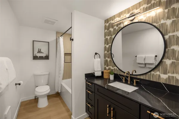 a white toilet sitting next to a white tub