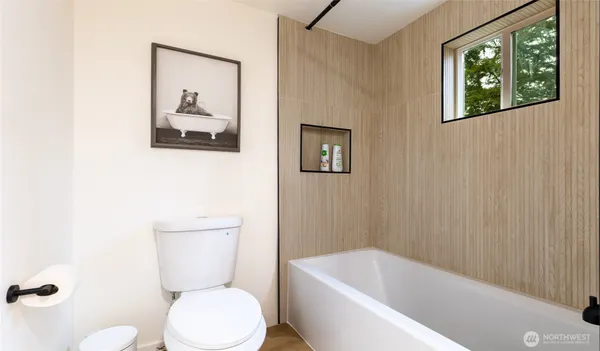 a bathroom with a tub and a window