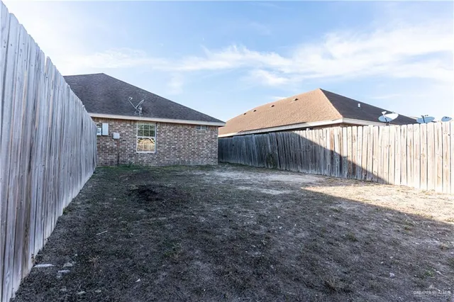 a view of a house with wooden fence
