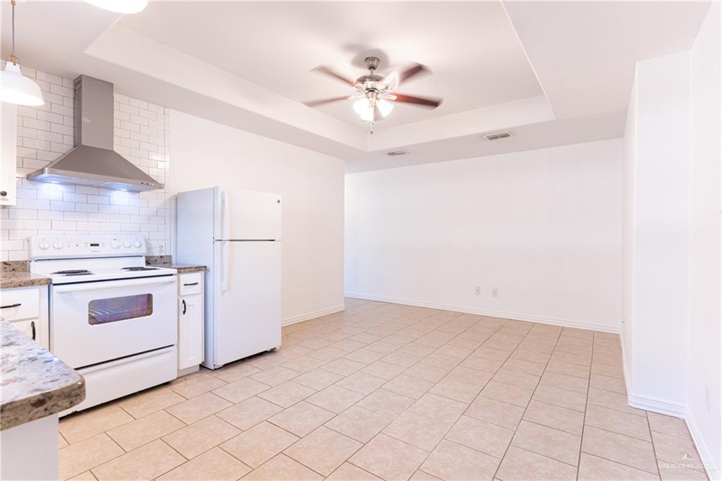 616 Jade Street Edinburg, TX 78541 - Photo 2 of 17 a view of a kitchen with a stove cabinets and a ceiling fan