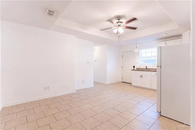 a view of a kitchen with a sink and a refrigerator