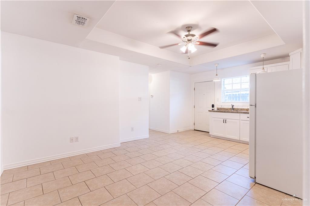 616 Jade Street Edinburg, TX 78541 - Photo 4 of 17 a view of a kitchen with a sink and a refrigerator