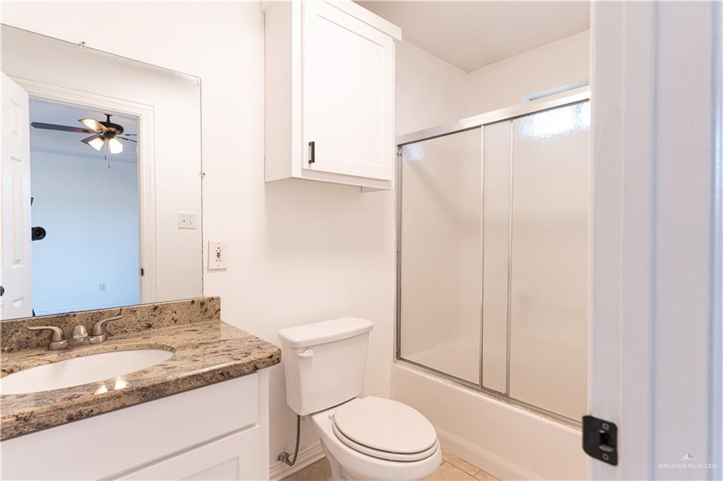 616 Jade Street Edinburg, TX 78541 - Photo 6 of 17 a bathroom with a granite countertop sink toilet and shower