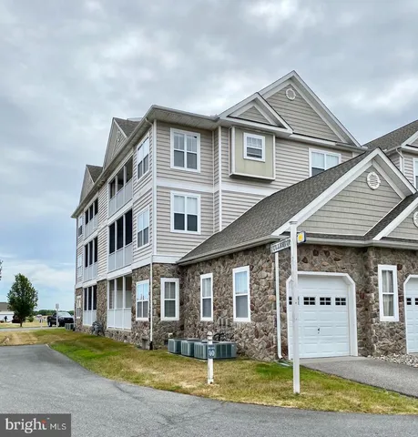 a front view of a house with swimming pool and porch