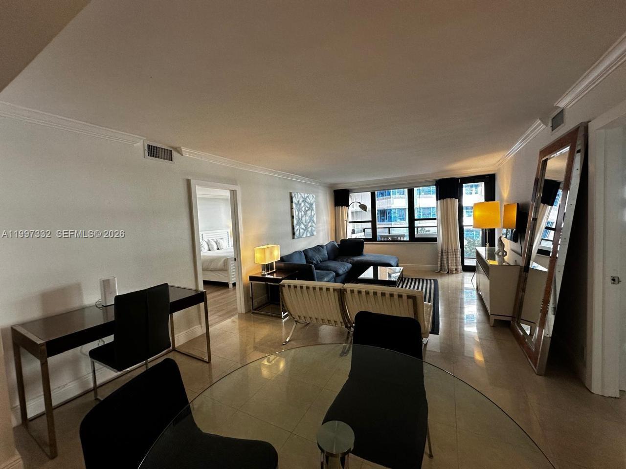 5225 Collins Avenue, Unit 614 Miami Beach, FL 33140 - Photo 5 of 8 a living room with furniture and a large window