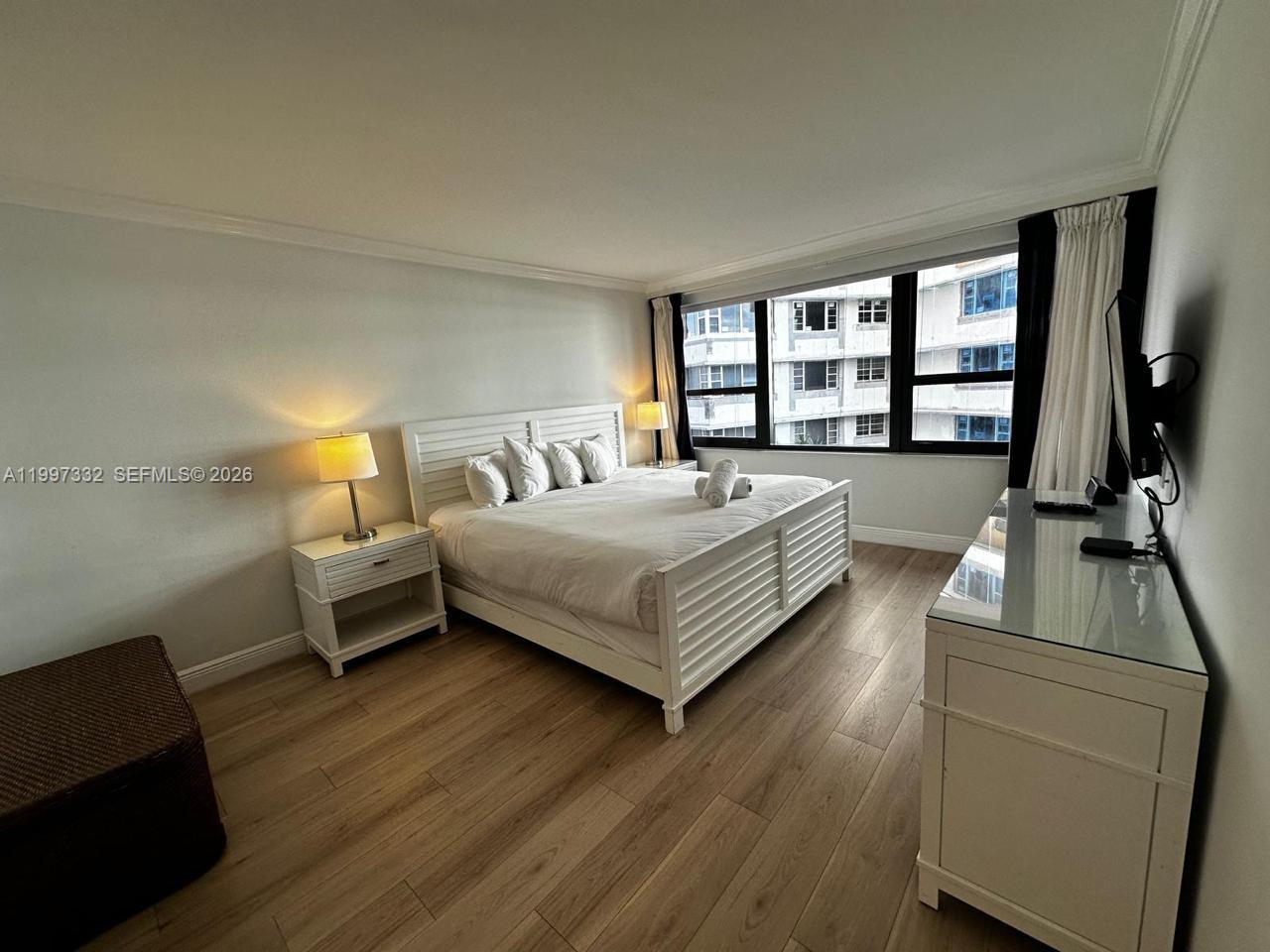 5225 Collins Avenue, Unit 614 Miami Beach, FL 33140 - Photo 8 of 8 a bed room with a bed and a couch
